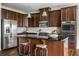 Close up of the updated kitchen with stainless steel appliances, tile backsplash, and dark wood cabinetry at 15144 Bentfield Ct, Fishers, IN 46037