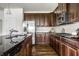 Gourmet kitchen features stainless steel appliances, granite countertops, dark cabinets and hardwood floors at 15144 Bentfield Ct, Fishers, IN 46037