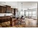 Open concept kitchen has stainless appliances, granite countertops, hardwood floors, and pendant lighting at 15144 Bentfield Ct, Fishers, IN 46037