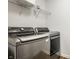 Laundry room features new front-load washer and dryer with shelving at 15144 Bentfield Ct, Fishers, IN 46037