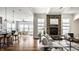 Bright, open living space features a stone fireplace, hardwood floors, and transitions to kitchen and dining spaces at 15144 Bentfield Ct, Fishers, IN 46037