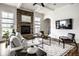 Comfortable living room includes a stone fireplace, ceiling fan, and television for relaxation and entertainment at 15144 Bentfield Ct, Fishers, IN 46037