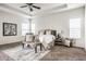 Relaxing main bedroom featuring a ceiling fan, bench, decorative pillows, and large rug at 15144 Bentfield Ct, Fishers, IN 46037