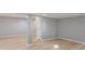 Basement with bright paint, wood floors and a white door for access to other areas at 158 Bloomfield Ln, Westfield, IN 46074
