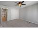Spacious bedroom featuring neutral carpeting, a ceiling fan, and a door to the hallway at 158 Bloomfield Ln, Westfield, IN 46074