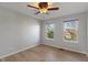 Bedroom features hardwood floors, a ceiling fan, and two windows at 158 Bloomfield Ln, Westfield, IN 46074