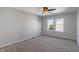 Bright bedroom with neutral carpet, a ceiling fan, and two windows offering a view of trees and blue sky at 158 Bloomfield Ln, Westfield, IN 46074