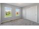 Bedroom features neutral carpet, two windows with a green view, and a sliding door closet at 158 Bloomfield Ln, Westfield, IN 46074