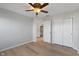 Bright bedroom featuring a ceiling fan, wood floors, and ensuite access to the bathroom at 158 Bloomfield Ln, Westfield, IN 46074