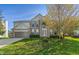 Charming two-story home with brick accents, attached garage and a beautifully landscaped front yard at 158 Bloomfield Ln, Westfield, IN 46074