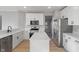 Modern kitchen with stainless steel appliances, white cabinets, an island, and light wood floors at 158 Bloomfield Ln, Westfield, IN 46074
