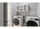Well-organized laundry room equipped with modern washer, dryer, and shelving at 158 Bloomfield Ln, Westfield, IN 46074