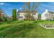 Exterior view showcasing the home's backyard, patio, and well-manicured lawn at 158 Bloomfield Ln, Westfield, IN 46074