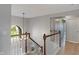 Elegant staircase with wood railing, white banisters, a chandelier and large window at 158 Bloomfield Ln, Westfield, IN 46074