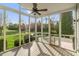 Bright sunroom with ceiling fan offers peaceful views of the landscaped backyard at 158 Bloomfield Ln, Westfield, IN 46074