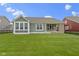 Well-manicured backyard with green grass, and view of home's back porch at 1747 Wellpark Dr, Westfield, IN 46074