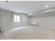 This unfinished basement offers carpet, a window, and a small white cabinet at 1747 Wellpark Dr, Westfield, IN 46074