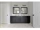 This bathroom features a double sink vanity, framed mirrors, white marble tile, and modern fixtures at 1747 Wellpark Dr, Westfield, IN 46074