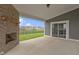 Covered outdoor patio with fireplace, overlooking the large lawn and neighboring homes at 1747 Wellpark Dr, Westfield, IN 46074