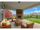 Outdoor living area with brick fireplace and seating, overlooking the backyard at 1747 Wellpark Dr, Westfield, IN 46074