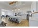 Bright kitchen features a large island, stainless steel appliances, modern lighting and light hardwood floors at 1747 Wellpark Dr, Westfield, IN 46074