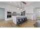 Bright kitchen features a large island, stainless steel appliances, modern lighting and light hardwood floors at 1747 Wellpark Dr, Westfield, IN 46074