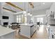 Bright kitchen with island and stainless appliances is open to the living room, with fireplace, and the dining room at 1747 Wellpark Dr, Westfield, IN 46074