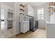 Laundry room featuring modern washer and dryer, lots of cabinets and wood-look floors at 1747 Wellpark Dr, Westfield, IN 46074