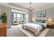 Bright main bedroom features lots of light, neutral decor, and tray ceiling at 1747 Wellpark Dr, Westfield, IN 46074