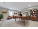 This office features a wood desk, carpet, a window, shelving, and colorful artwork at 1747 Wellpark Dr, Westfield, IN 46074