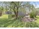 View of backyard with garden pond and sitting area under a large weeping willow tree at 1850 Cruft St, Indianapolis, IN 46203