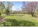 Large, grassy backyard featuring mature trees and potential for various outdoor activities and landscaping at 1850 Cruft St, Indianapolis, IN 46203