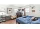 A bedroom features hardwood floors, windows, and furnishings including a bed, dresser, and nightstand at 1850 Cruft St, Indianapolis, IN 46203