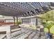 View of covered deck with patio furniture, hanging hammock, and detached garage in the background at 1850 Cruft St, Indianapolis, IN 46203