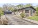 Charming stone home with detached garage, long driveway, and well-maintained landscaping at 1850 Cruft St, Indianapolis, IN 46203