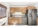 A bright kitchen features wooden cabinets, dark countertops, stainless steel appliances, and modern lighting at 1850 Cruft St, Indianapolis, IN 46203