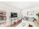 Cozy living room with hardwood floors, sectional sofa, console table, and view into eat-in kitchen at 1850 Cruft St, Indianapolis, IN 46203