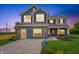 Charming two-story home boasts a brick-accented facade, blue siding, and an inviting covered entry at 187 Luna Pl, Shelbyville, IN 46176