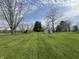 Expansive backyard with shed, play set, and lush greenery at 1873 W 950 S, Pendleton, IN 46064