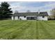 Well-maintained backyard featuring a sunroom and lush green lawn, perfect for outdoor enjoyment at 1873 W 950 S, Pendleton, IN 46064