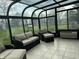 Relaxing sunroom with comfortable seating and panoramic views of the surrounding greenery at 1873 W 950 S, Pendleton, IN 46064