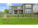 Well-manicured backyard featuring an iron fence, established greenery, and a covered patio with outdoor seating at 1979 Lunenburg Dr, Westfield, IN 46074