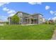Expansive backyard view highlighting a spacious lawn and inviting covered patio at 1979 Lunenburg Dr, Westfield, IN 46074
