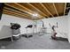 Unfinished basement transformed into a home gym with treadmills and weightlifting equipment at 1979 Lunenburg Dr, Westfield, IN 46074