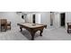 Basement with a pool table, stairs to the main level, and full-size bar at 1979 Lunenburg Dr, Westfield, IN 46074