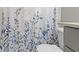 Close up on full bathroom with toilet, shower curtain, gray cabinets, sink and faucet at 1979 Lunenburg Dr, Westfield, IN 46074