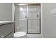 Bathroom featuring glass shower doors, white toilet, and gray walls, showcasing a clean and modern design at 1979 Lunenburg Dr, Westfield, IN 46074