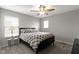 Cozy bedroom with a queen-sized bed, ceiling fan, and two windows, creating a tranquil and inviting space at 1979 Lunenburg Dr, Westfield, IN 46074