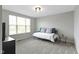 Bedroom featuring a daybed with blue pillows, a glass table, and a ceiling light, creating a cozy atmosphere at 1979 Lunenburg Dr, Westfield, IN 46074