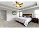 Bedroom featuring gray carpet, ceiling fan, a bed, windows and lamps at 1979 Lunenburg Dr, Westfield, IN 46074